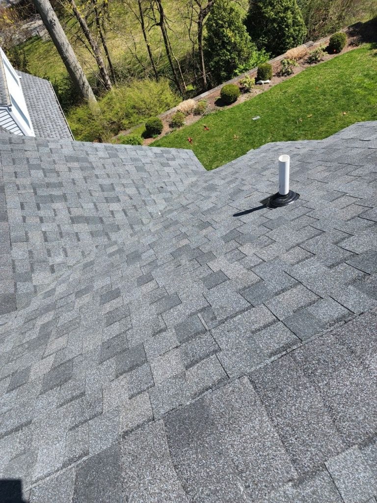 A grey shingle roof and yard in Connecticut