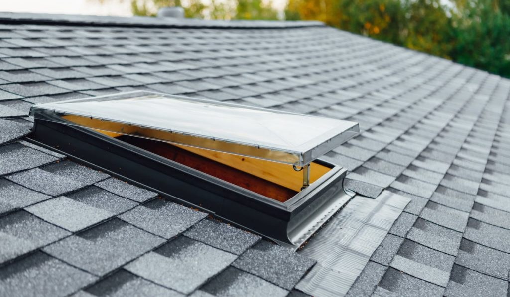 A skylight installed in a shingled roof